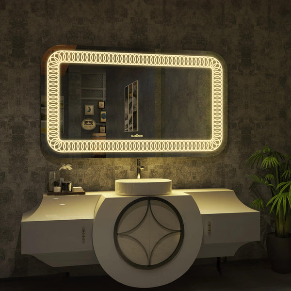 Modern bathroom vanity with a rectangular mirror, a white ceramic sink with a chrome faucet, and a built-in dimmable LED light in the mirror. Text overlay says "Upgrade your bathroom with our all-in-one vanity set. The mirror features a built-in dimmable LED light for perfect lighting every time." This space-saving vanity set is a great choice for small bathrooms.