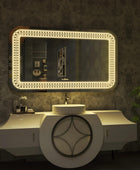 Modern bathroom vanity with a rectangular mirror, a white ceramic sink with a chrome faucet, and a built-in dimmable LED light in the mirror. Text overlay says 