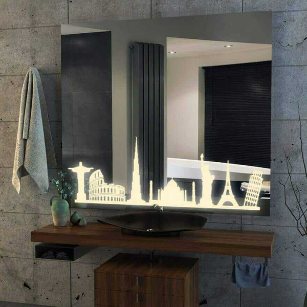 A bathroom mirror with a decorative border featuring a silhouette of famous landmarks in LED, including the Eiffel Tower, Leaning Tower of Pisa, Statue of Liberty, and Great Wall of China. The mirror is mounted on a bathroom wall with a faucet and sink below.