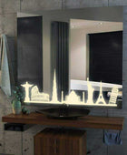 A bathroom mirror with a decorative border featuring a silhouette of famous landmarks in LED, including the Eiffel Tower, Leaning Tower of Pisa, Statue of Liberty, and Great Wall of China. The mirror is mounted on a bathroom wall with a faucet and sink below.