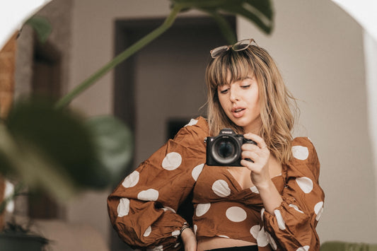girl taking mirror selfies with camera
