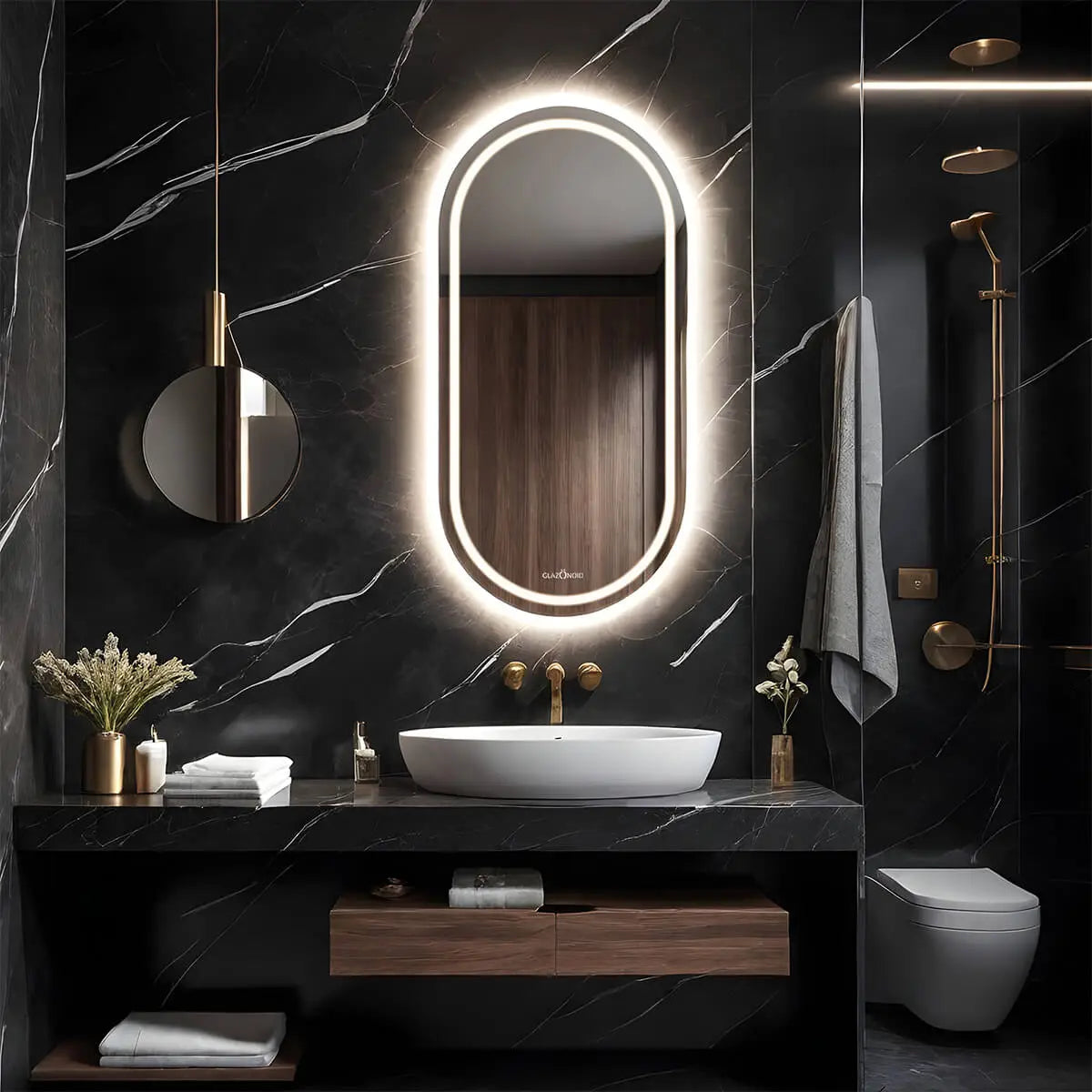 A modern bathroom vanity with a black finish, polished chrome sink and a capsule shaped LED mirror with a dimmable LED light behind it. The mirror is mounted on the wall above the sink.