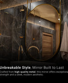 A bathroom vanity set with a gold-framed mirror. The mirror is mounted on the wall using the pipes that hold on to the roof, above a white ceramic sink with a polished chrome faucet. There is a white towel hanging from a rack on the right side of the image.