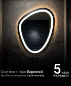 A pebble shaped bathroom mirror with a LED strip light. The text overlay reads 5 year warranty that is being offered by the brand for the products.