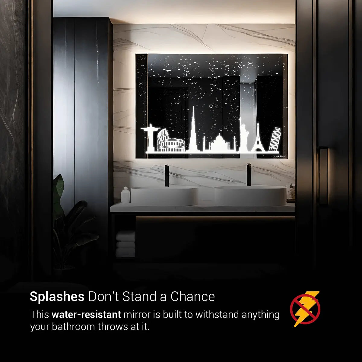A rectangular bathroom mirror with a picture of a city skyline printed on it. The text "Splashes Don't Stand a Chance" is written across the top of the mirror. The text below the skyline reads: "This water-resistant mirror is built to withstand anything your bathroom throws at it."