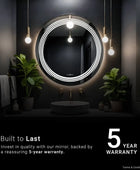 A close-up of a wall-mounted bathroom mirror with a built-in LED light strip. The mirror frameless and has a classic design. Text overlay reads 