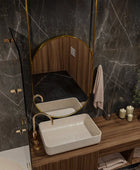 A bathroom shelf with a black metal frame featuring two glass jars with bamboo lids filled with cotton balls and cotton swabs. A white ceramic soap dispenser with a matte black pump sits next to the jars. In the background is a metal framed mirror with a gold finish.