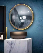Bathroom vanity set with a round mirror with a brushed metal frame and a white ceramic sink with a chrome faucet. Text overlay says 'Upgrade your bathroom with our all-in-one vanity set. The mirror completes the sleek and stylish design.' This modern vanity set is perfect for a quick bathroom refresh.