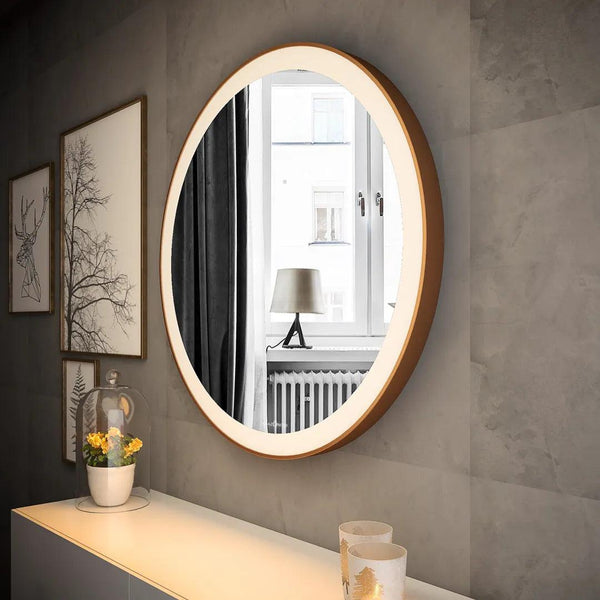 White dresser with a large round mirror with a stainless steel frame on top. The mirror is tilted slightly upwards. There is a small potted plant and a jewelry box on the dresser surface. This stylish dresser with mirror is perfect for any bedroom.