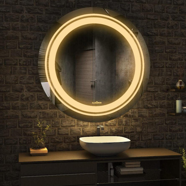 A close-up of a round bathroom mirror with a built-in LED light. The mirror has a frameless design and a two rows of LED lights along edge.washbasin