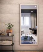 Standing rectangular wall mirror in living room