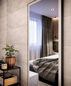 Standing rectangular wall mirror in bedroom